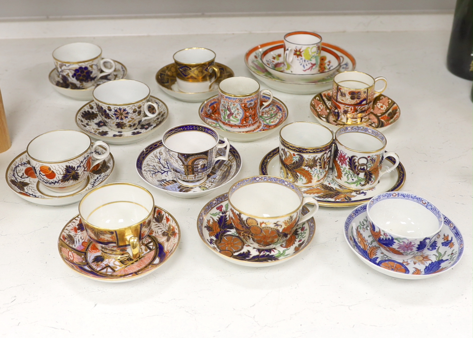 Six mixed English 1800-1820 porcelain cabinet cups and saucers, three similar coffee cans and saucers, a matching spoon stand and two coffee cans, a saucer dish, coffee can plus saucer and a tea bowl and matching saucer